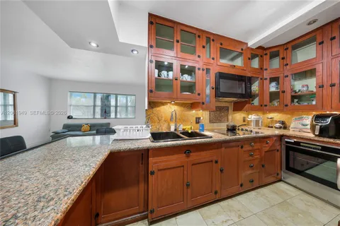 a kitchen with stainless steel appliances granite countertop a stove and cabinets