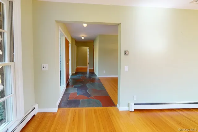 a view of a room with wooden floor