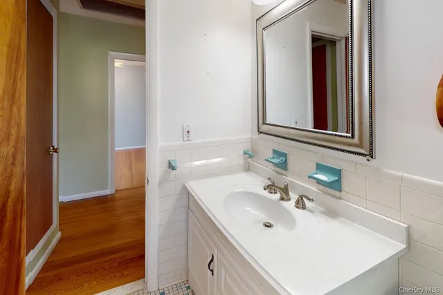 a bathroom with a sink vanity and mirror