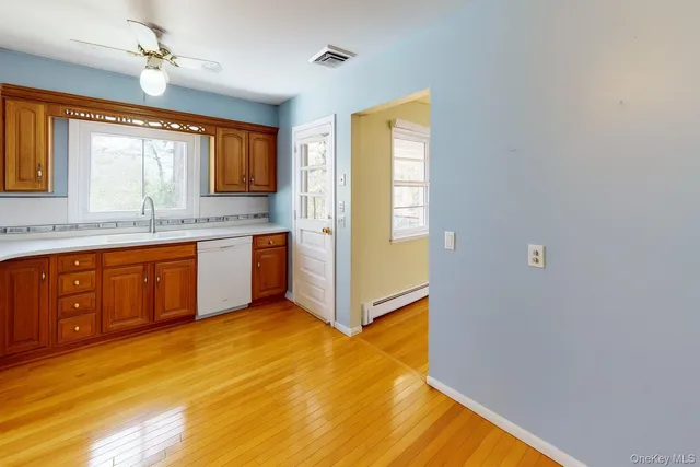 a view of a kitchen with wooden floor and a sink