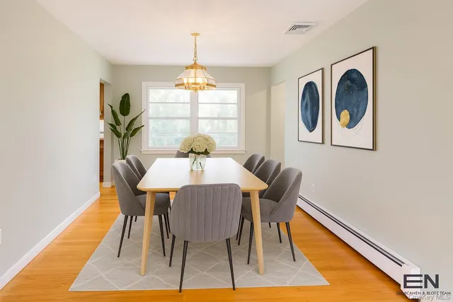 a view of a dining room with furniture wooden floor and chandelier