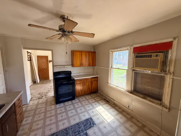 a kitchen with granite countertop a refrigerator and a sink