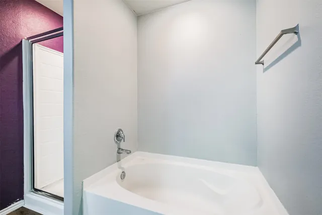 a view of a backyard with table and chairs and wooden fence