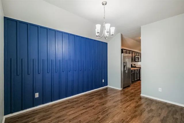 a kitchen with stainless steel appliances granite countertop a sink stove microwave and refrigerator