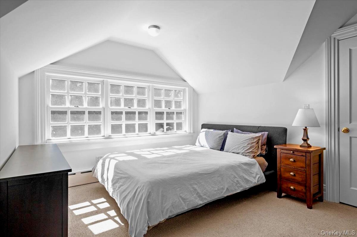 245 River Road Nyack, NY 10960 - Photo 38 of 45 Carpeted bedroom featuring a baseboard heating unit and vaulted ceiling