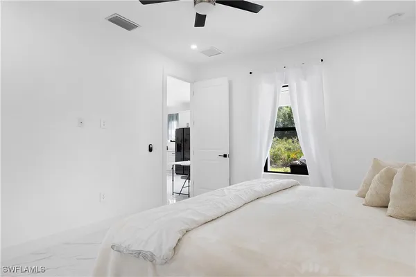 a bathroom with a sink mirror and vanity