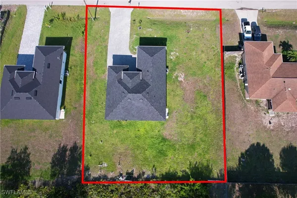 an aerial view of residential houses with outdoor space and river