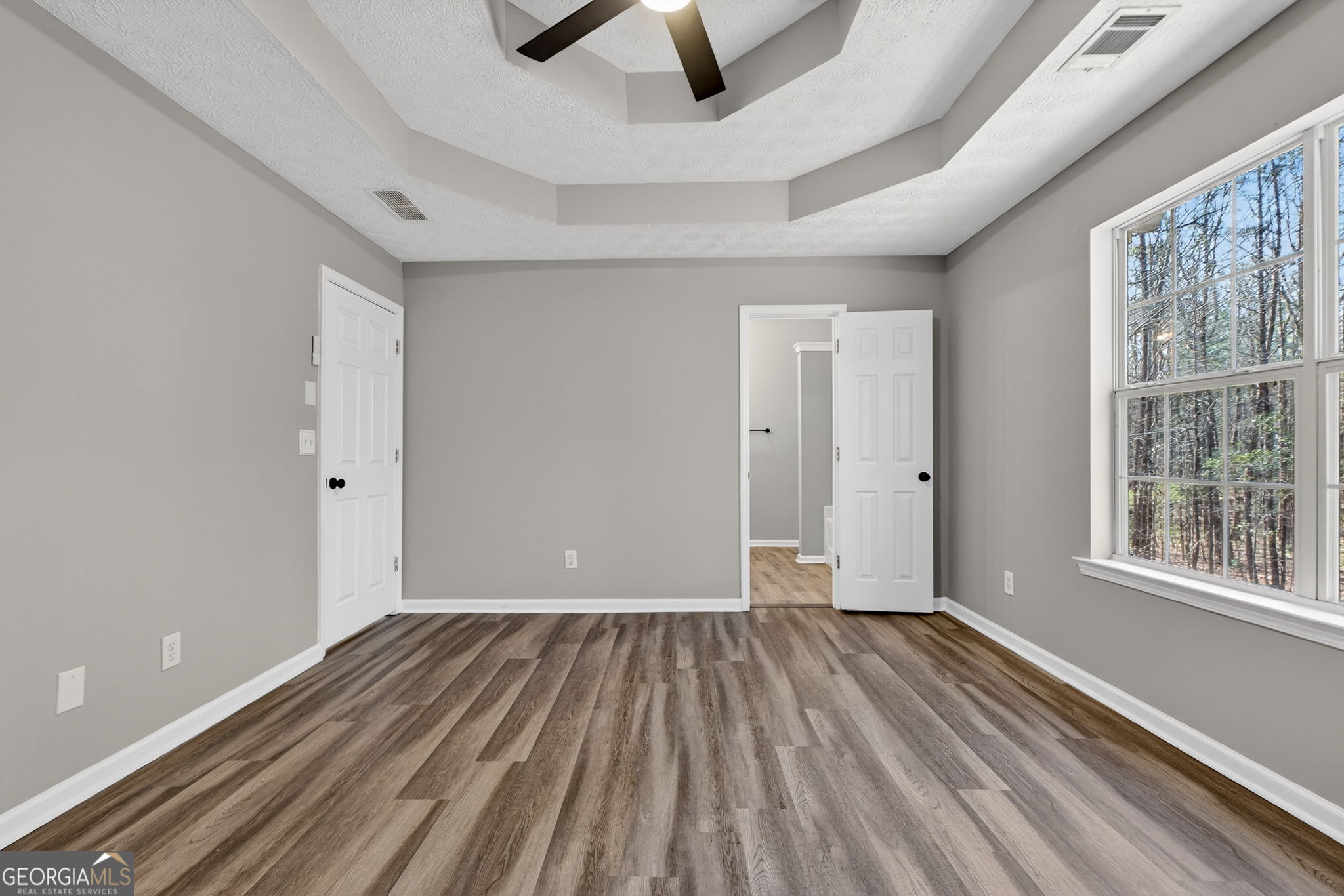 224 Stillwater Court Hampton, GA 30228 - Photo 11 of 44 wooden floor in an empty room with a window