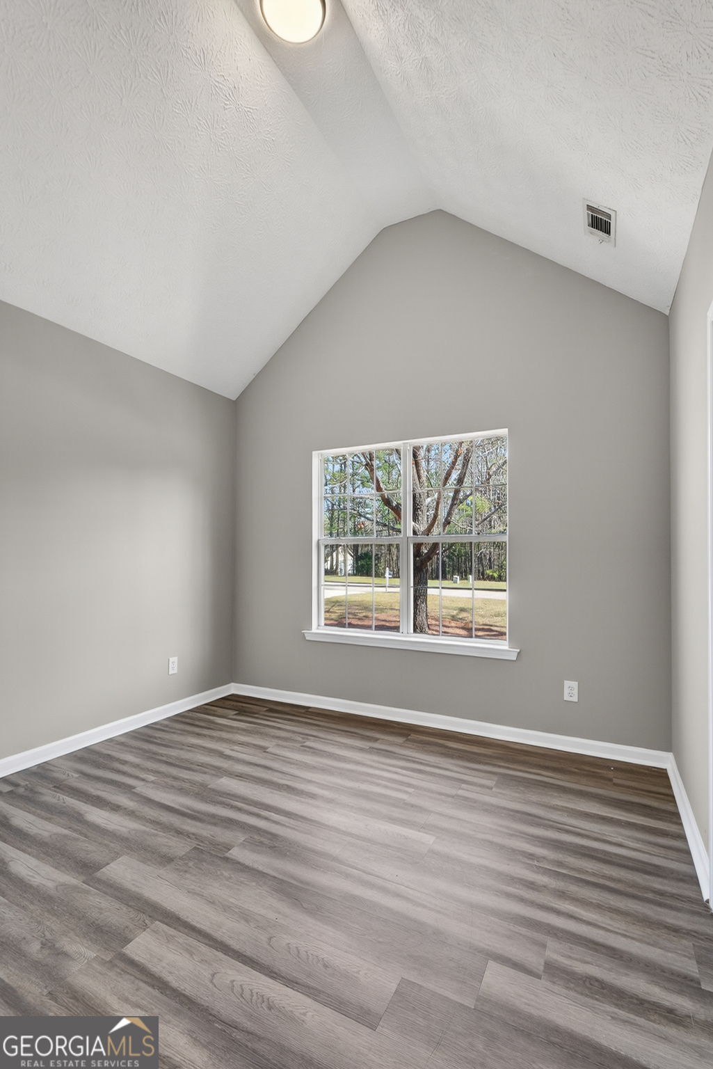 224 Stillwater Court Hampton, GA 30228 - Photo 25 of 44 a view of an empty room with wooden floor and a window