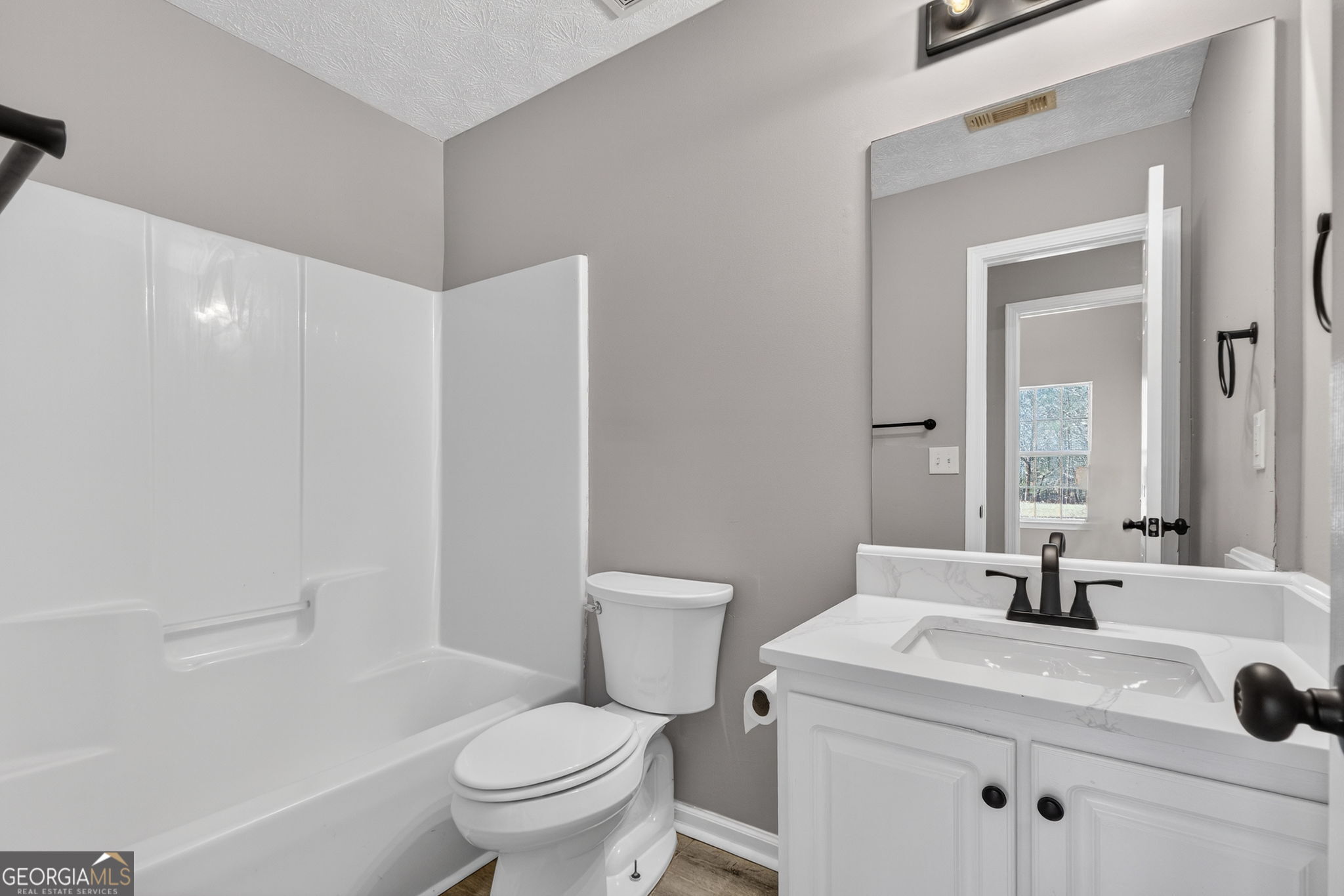 224 Stillwater Court Hampton, GA 30228 - Photo 28 of 44 a bathroom with a sink toilet vanity and tub