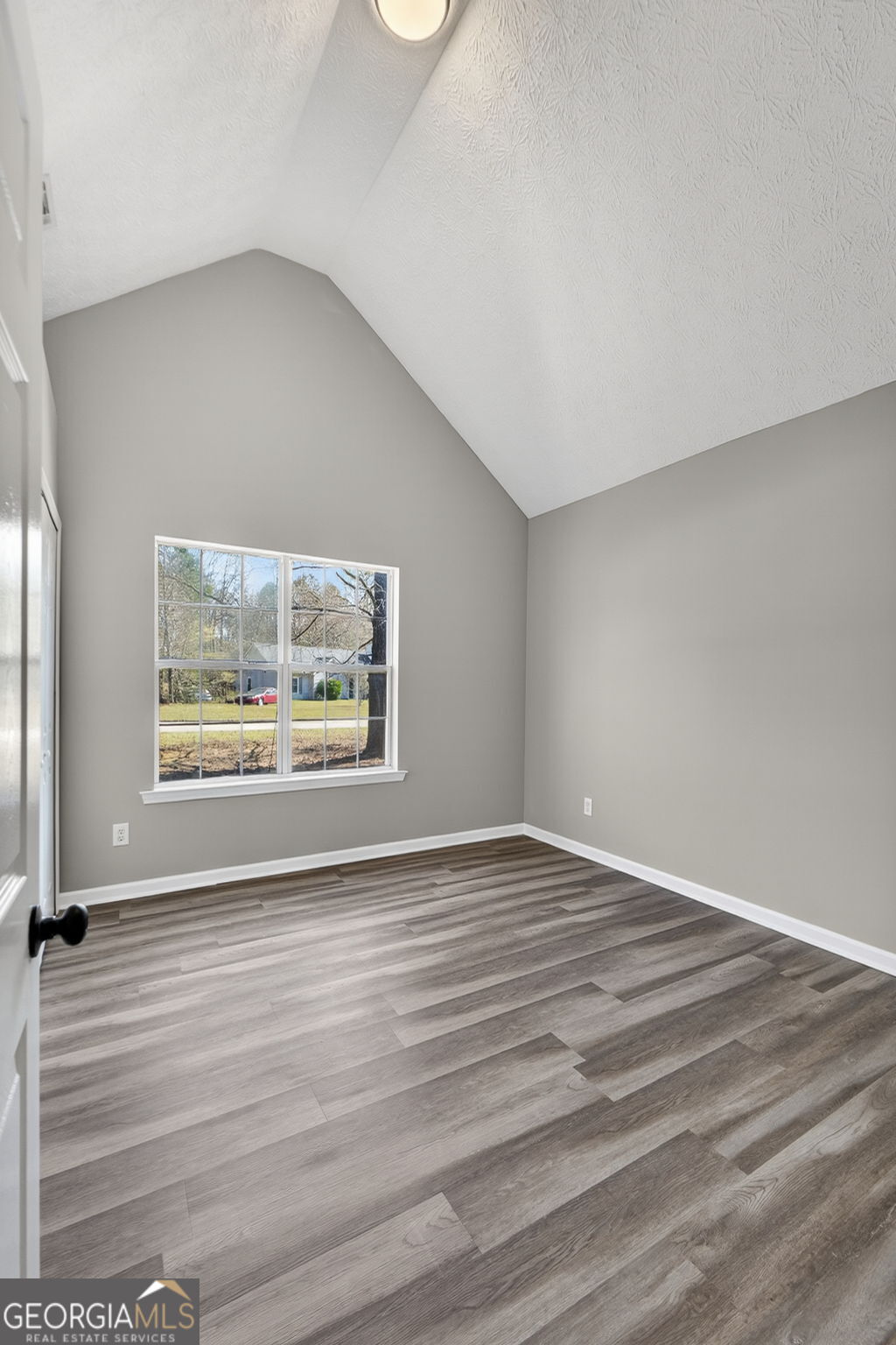 224 Stillwater Court Hampton, GA 30228 - Photo 30 of 44 a view of an empty room with a window and wooden floor