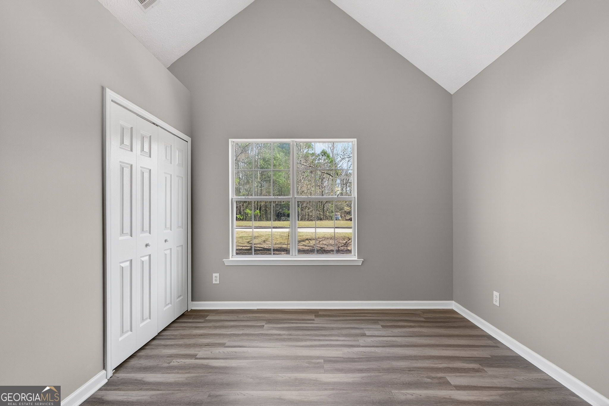 224 Stillwater Court Hampton, GA 30228 - Photo 31 of 44 an empty room with wooden floor and windows