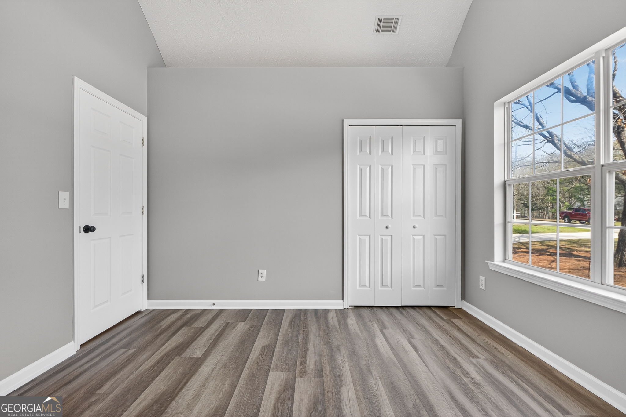 224 Stillwater Court Hampton, GA 30228 - Photo 32 of 44 a view of an empty room with wooden floor and a window