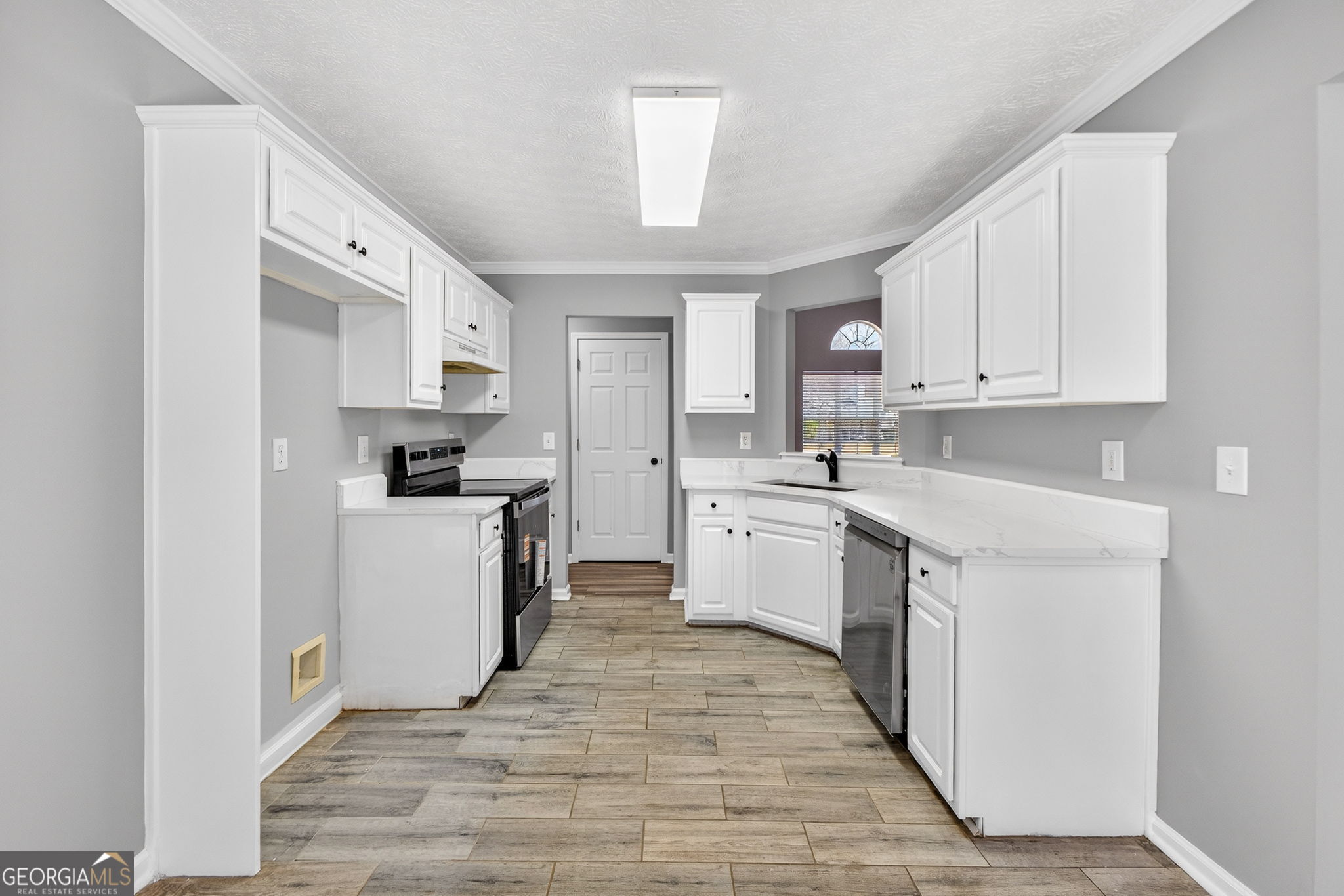 224 Stillwater Court Hampton, GA 30228 - Photo 6 of 44 a kitchen with white cabinets appliances and sink