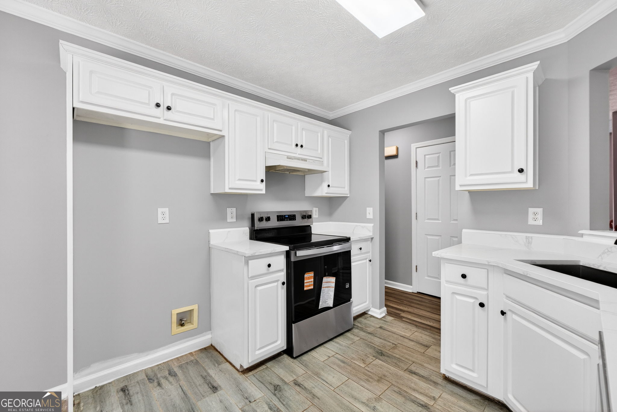 224 Stillwater Court Hampton, GA 30228 - Photo 8 of 44 a kitchen with stainless steel appliances white cabinets and a refrigerator