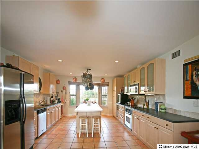 105 Bucks Mill Road Colts Neck, NJ 07722 - Photo 3 of 3 a large kitchen with stainless steel appliances kitchen island granite countertop a large counter top stainless steel appliances and cabinets