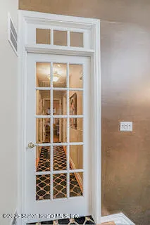 a view of a dining room with furniture and chandelier