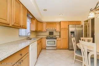 a dining room with furniture a rug and wooden floor