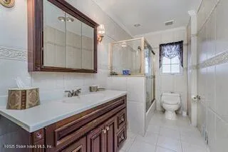 a bathroom with a sink mirror and toilet