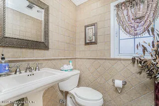 a bedroom with a bed dresser and a chandelier