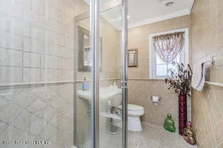 a view of a hallway with wooden floor and a window