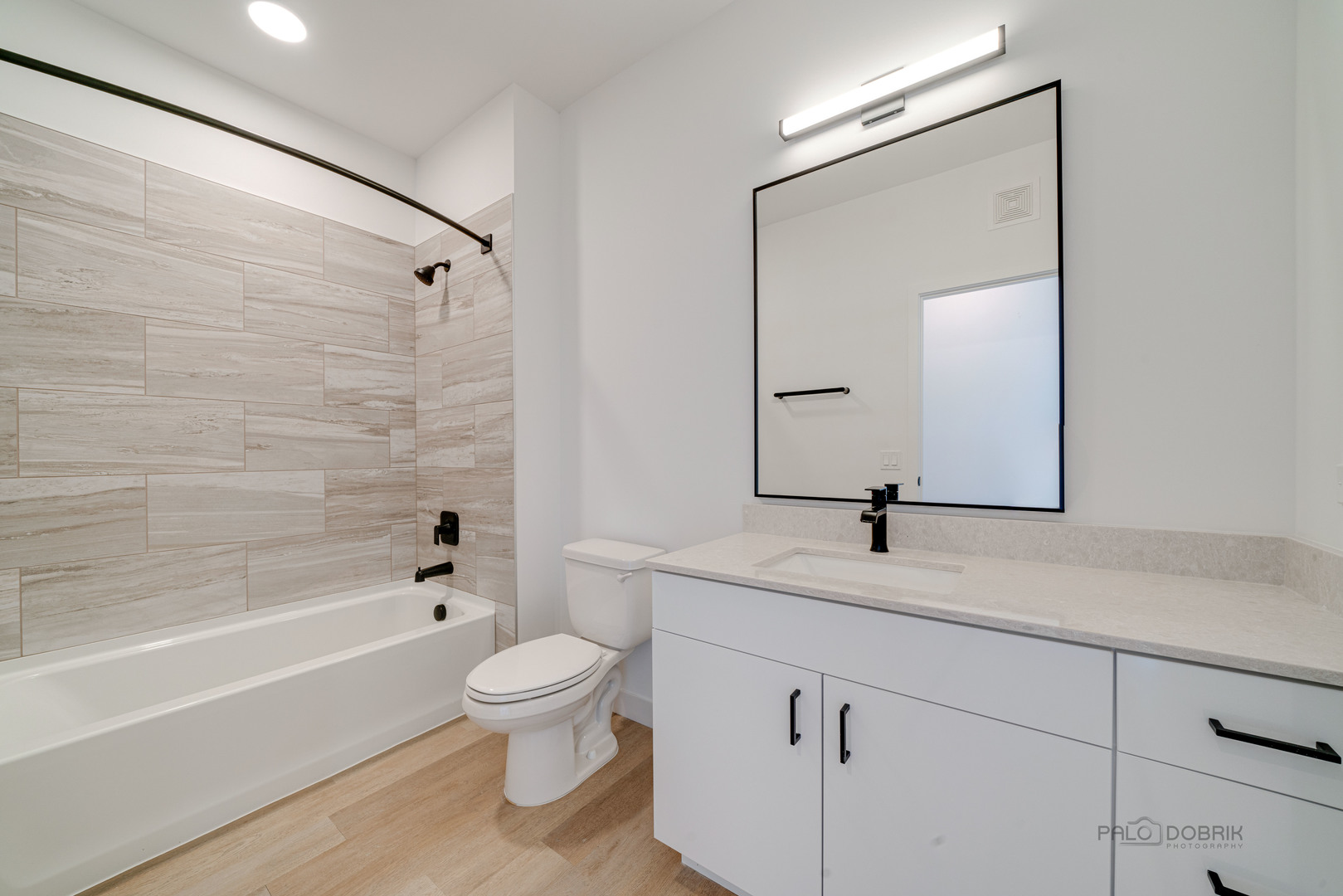 750 Hawthorn Row, Unit 4166 Vernon Hills, IL 60061 - Photo 19 of 24 a bathroom with a granite countertop sink a toilet a mirror and bathtub