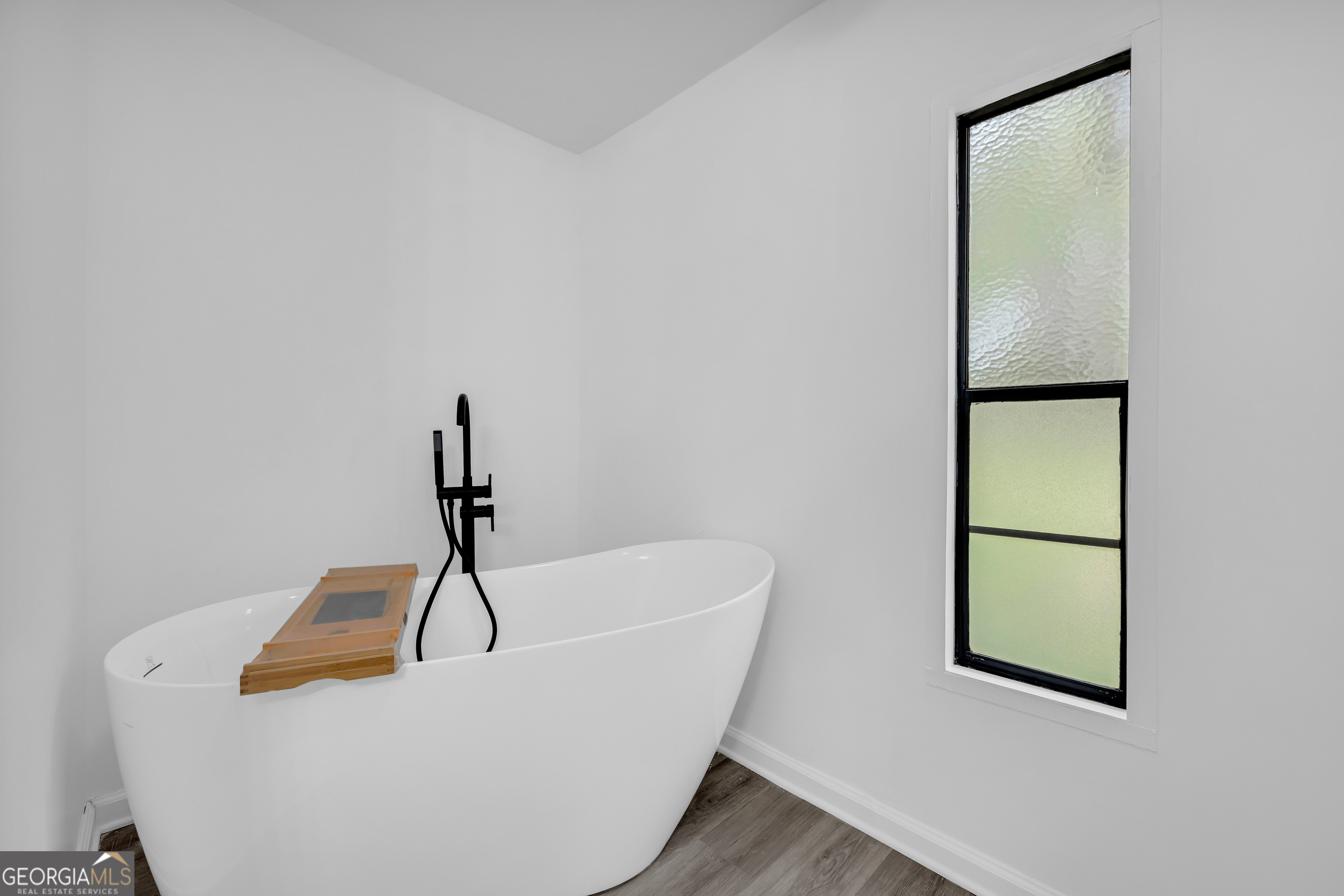 1144 Wolfskin Road Arnoldsville, GA 30619 - Photo 16 of 41 a white bath tub sitting in a bathroom