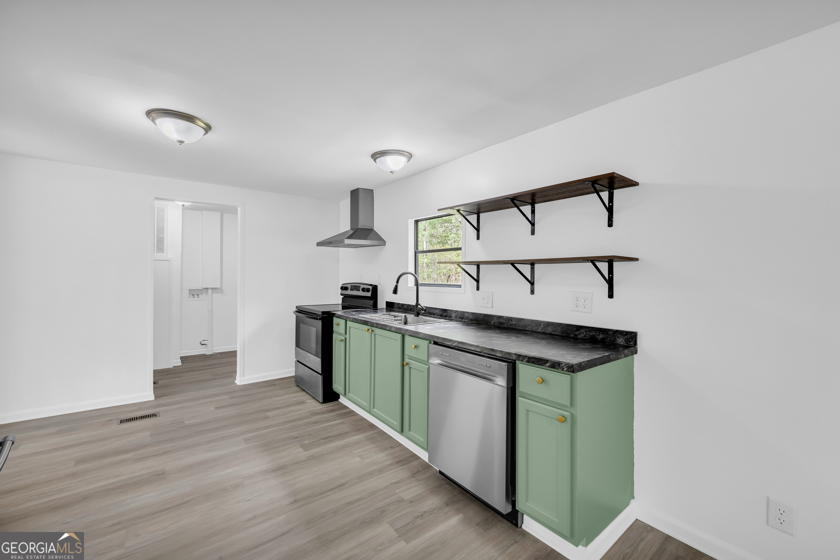 1144 Wolfskin Road Arnoldsville, GA 30619 - Photo 21 of 41 a kitchen with stainless steel appliances granite countertop a sink and cabinets
