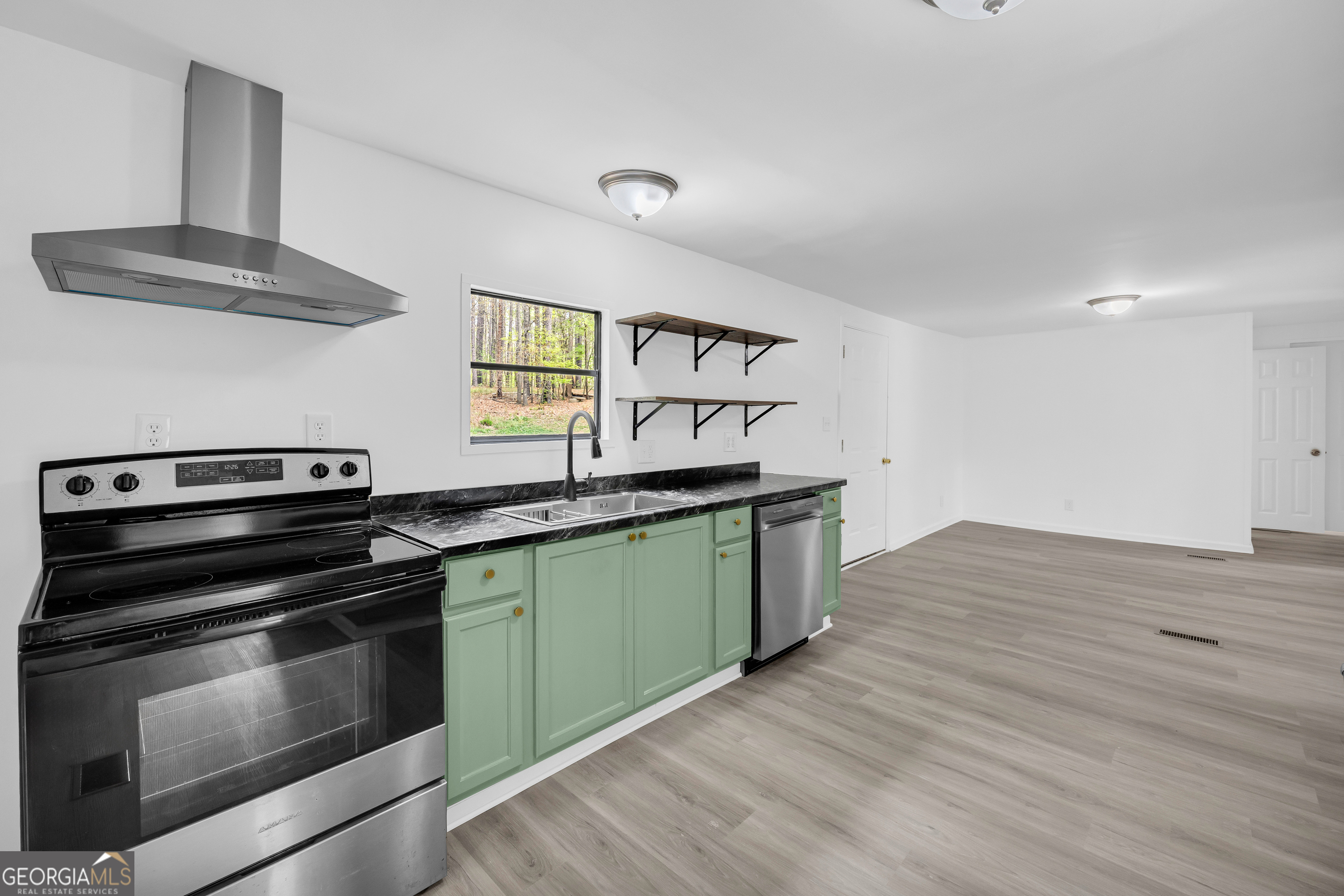 1144 Wolfskin Road Arnoldsville, GA 30619 - Photo 23 of 41 a kitchen with granite countertop a stove and a sink