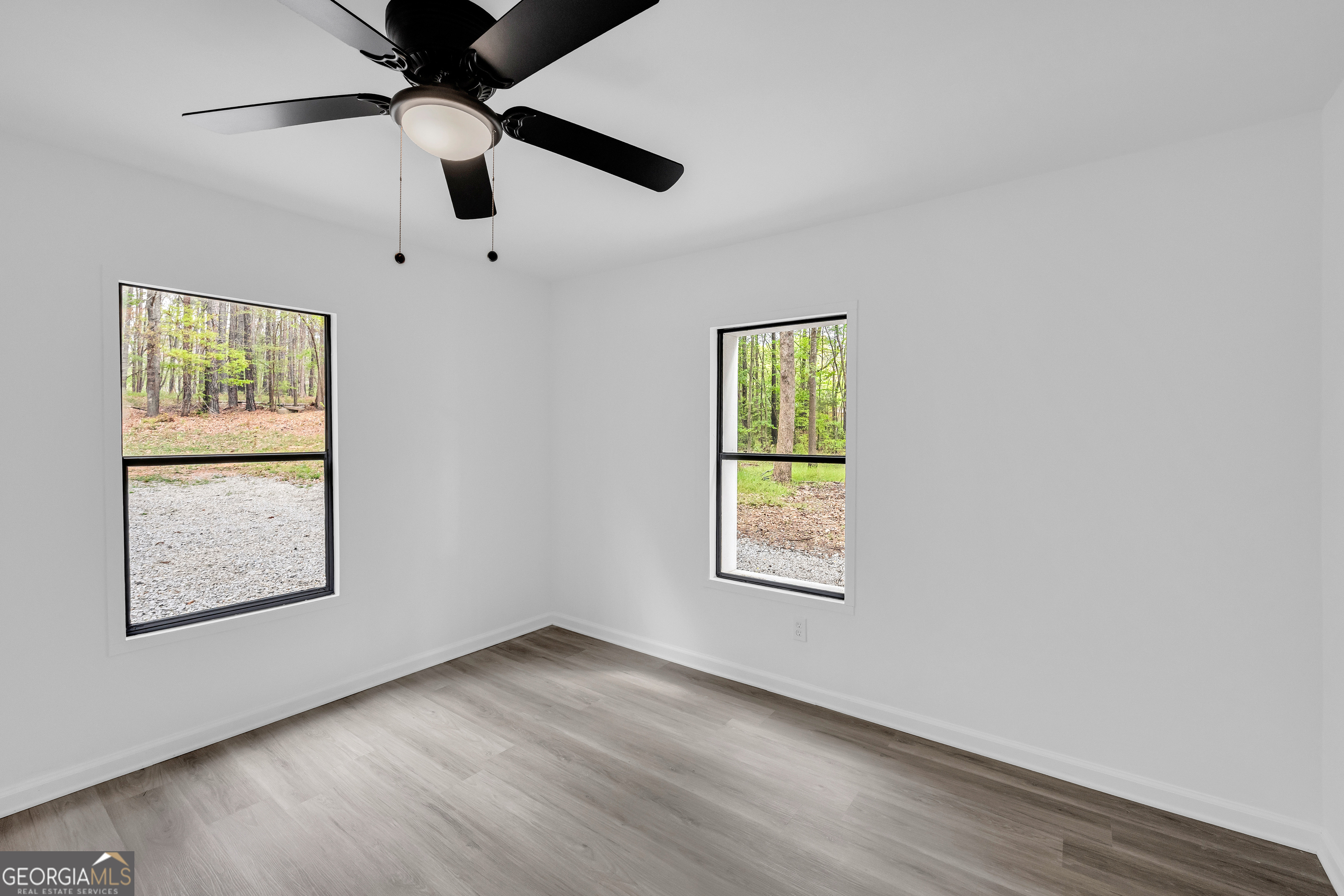 1144 Wolfskin Road Arnoldsville, GA 30619 - Photo 27 of 41 an empty room with windows and ceiling fan