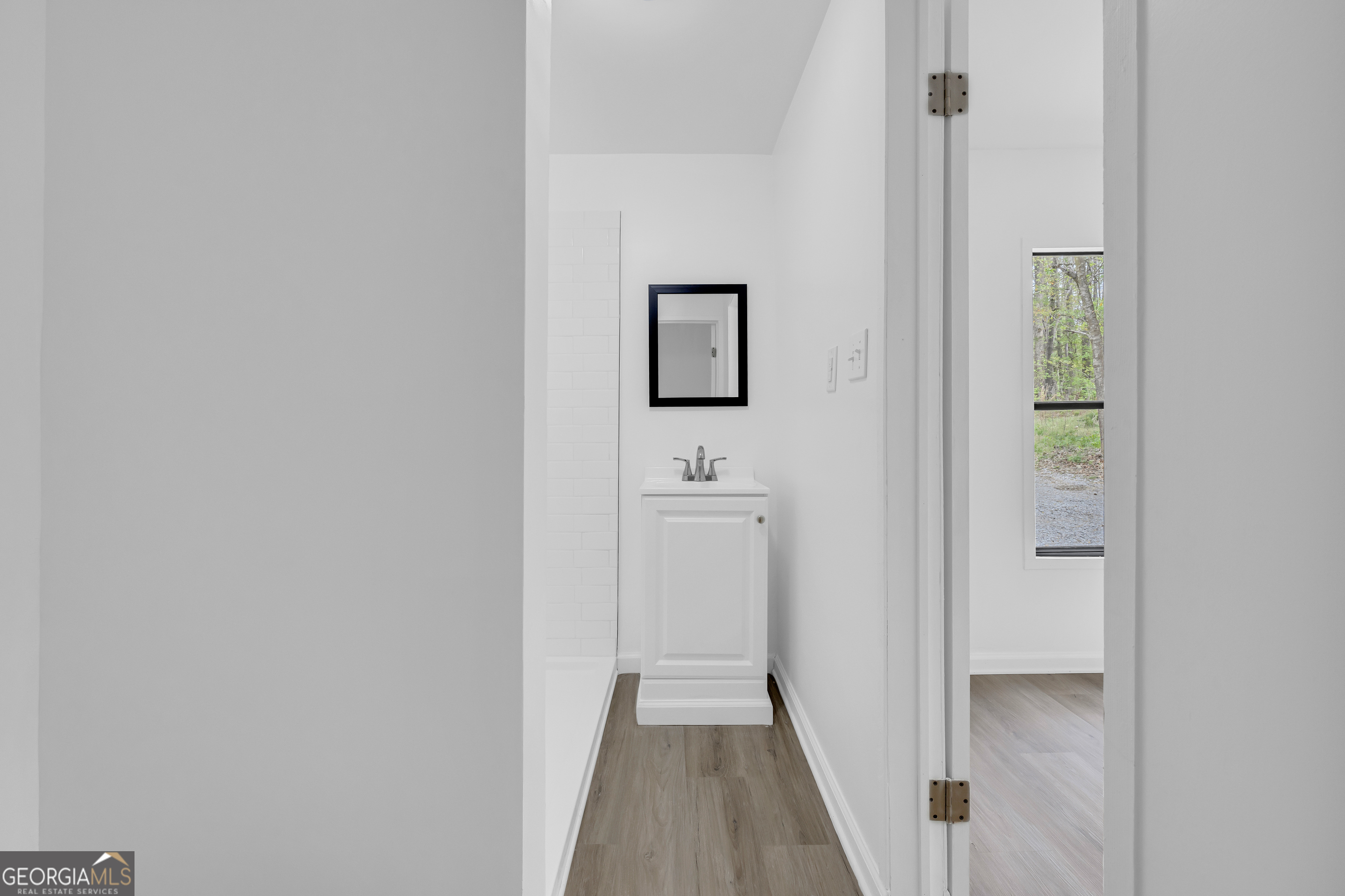 1144 Wolfskin Road Arnoldsville, GA 30619 - Photo 30 of 41 a bathroom with a sink and a mirror