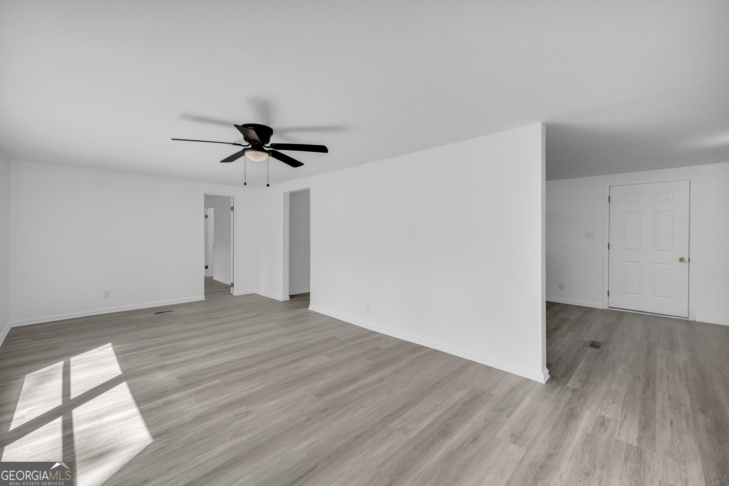 1144 Wolfskin Road Arnoldsville, GA 30619 - Photo 6 of 41 a view of empty room with wooden floor and ceiling fan