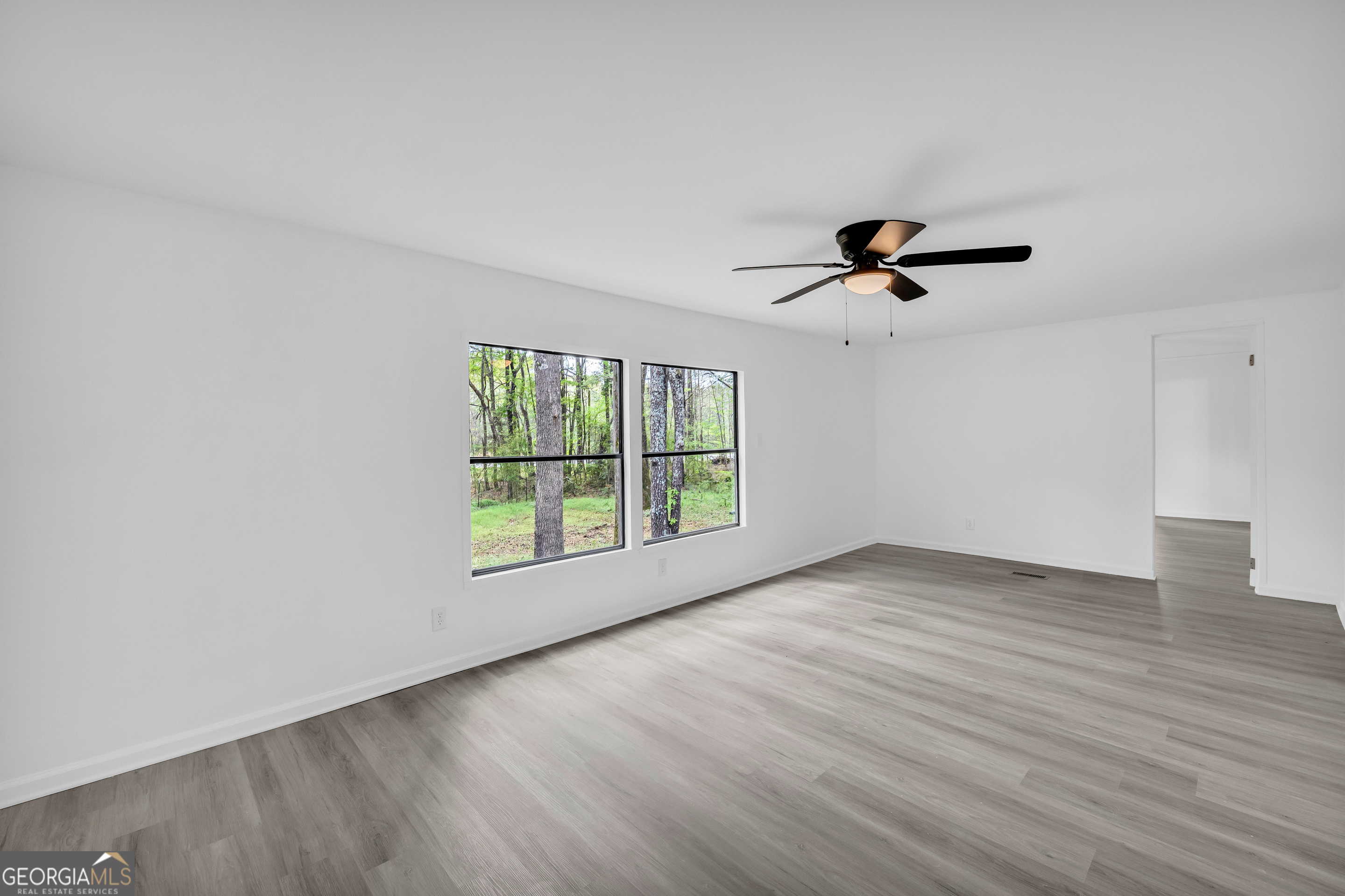 1144 Wolfskin Road Arnoldsville, GA 30619 - Photo 7 of 41 wooden floor in an empty room with a window