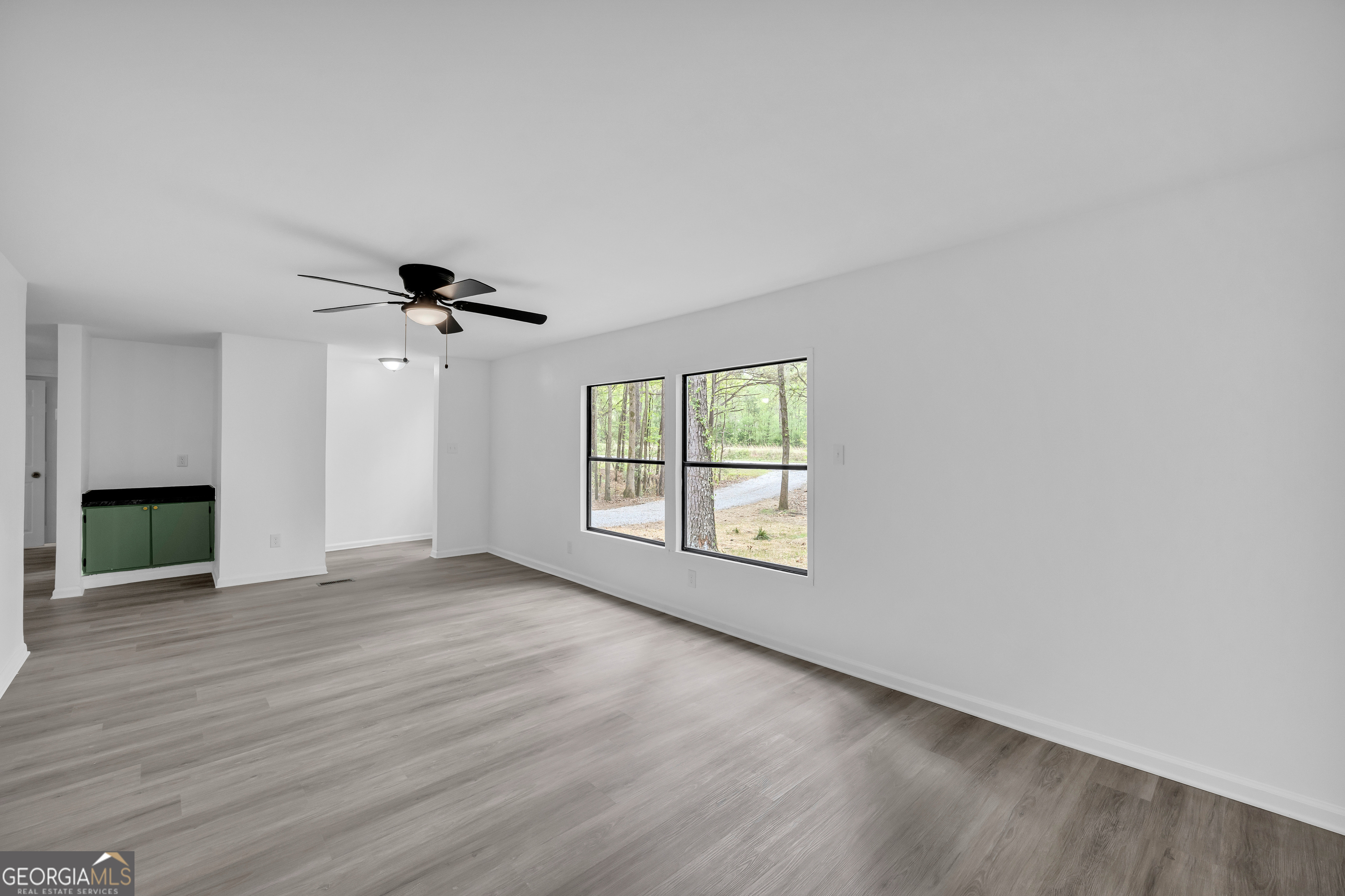 1144 Wolfskin Road Arnoldsville, GA 30619 - Photo 8 of 41 a view of empty room with wooden floor and fan
