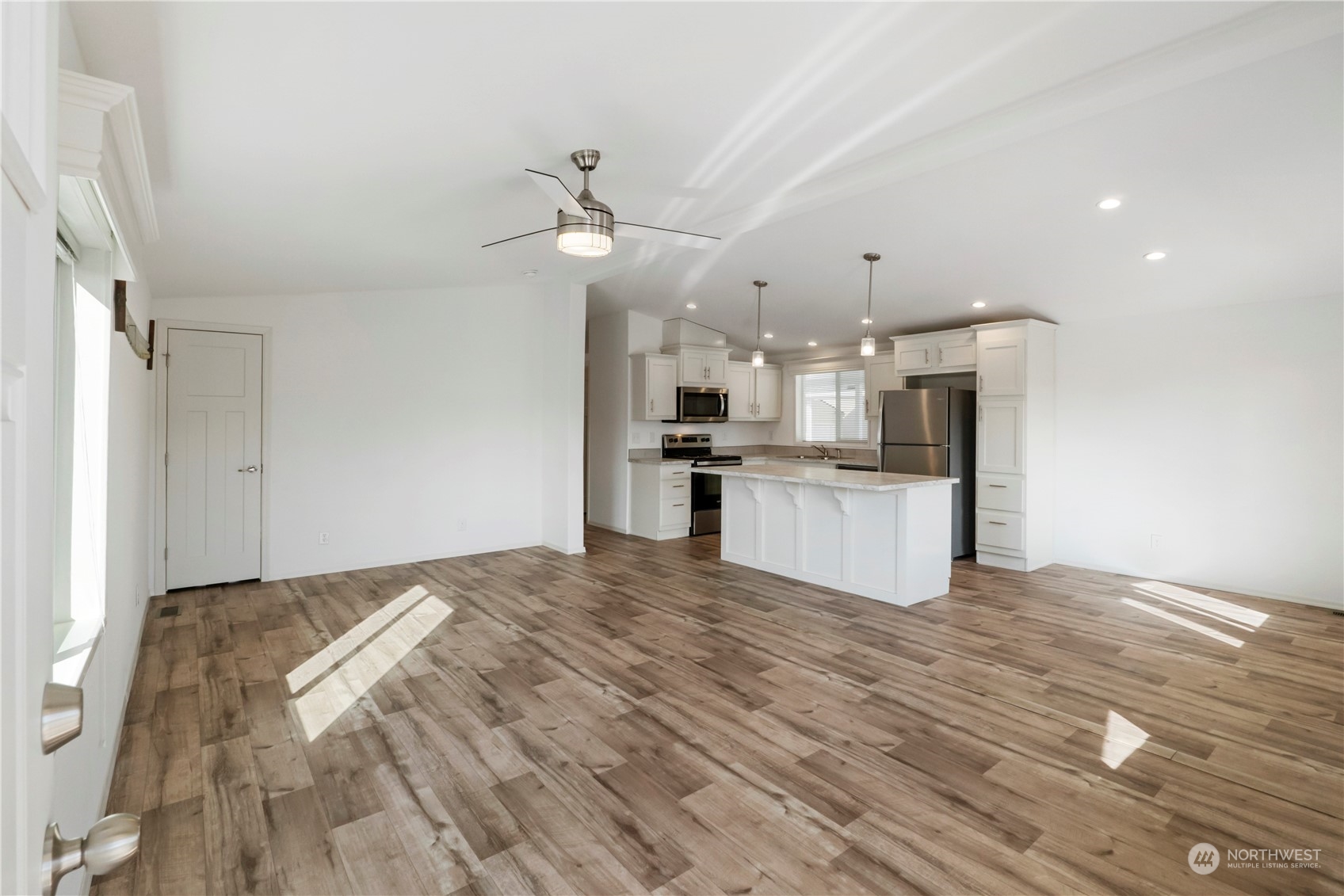 943 Pine Drive Enumclaw, WA 98022 - Photo 5 of 21 a view of kitchen with wooden floor and window