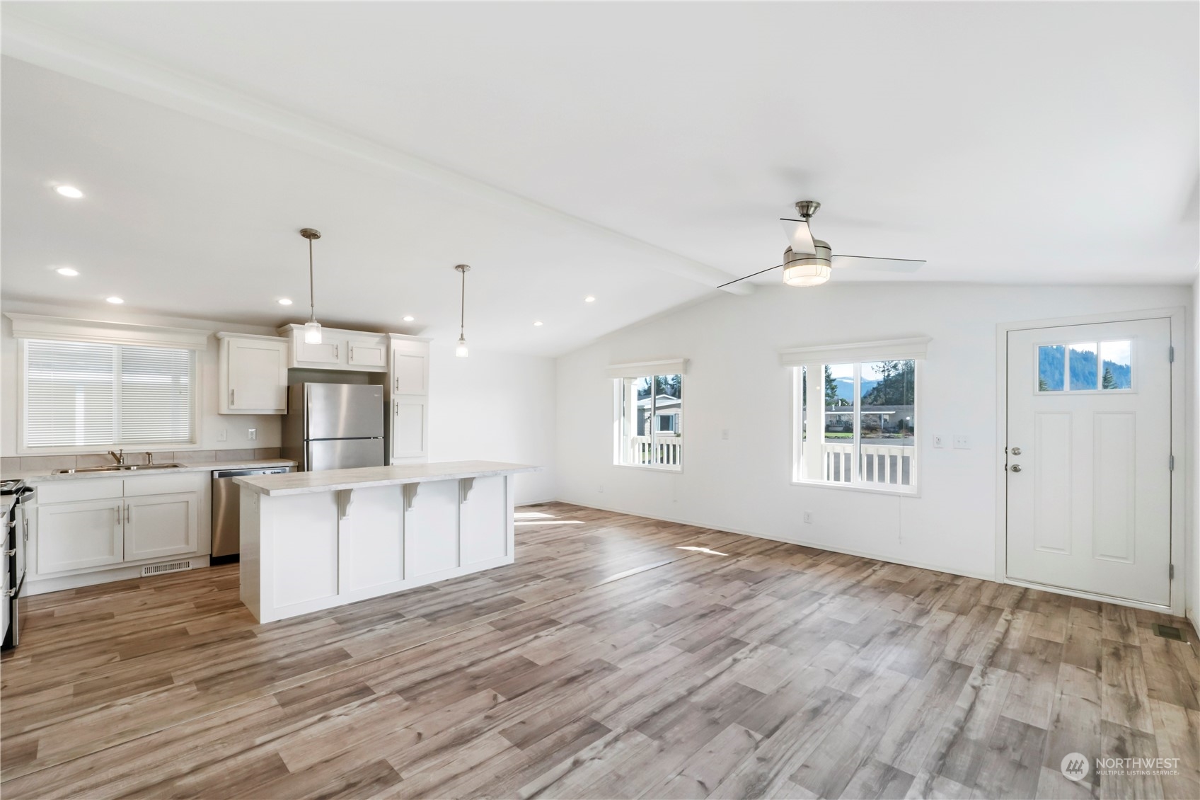 943 Pine Drive Enumclaw, WA 98022 - Photo 9 of 21 a view of kitchen with wooden floor electronic appliances and window