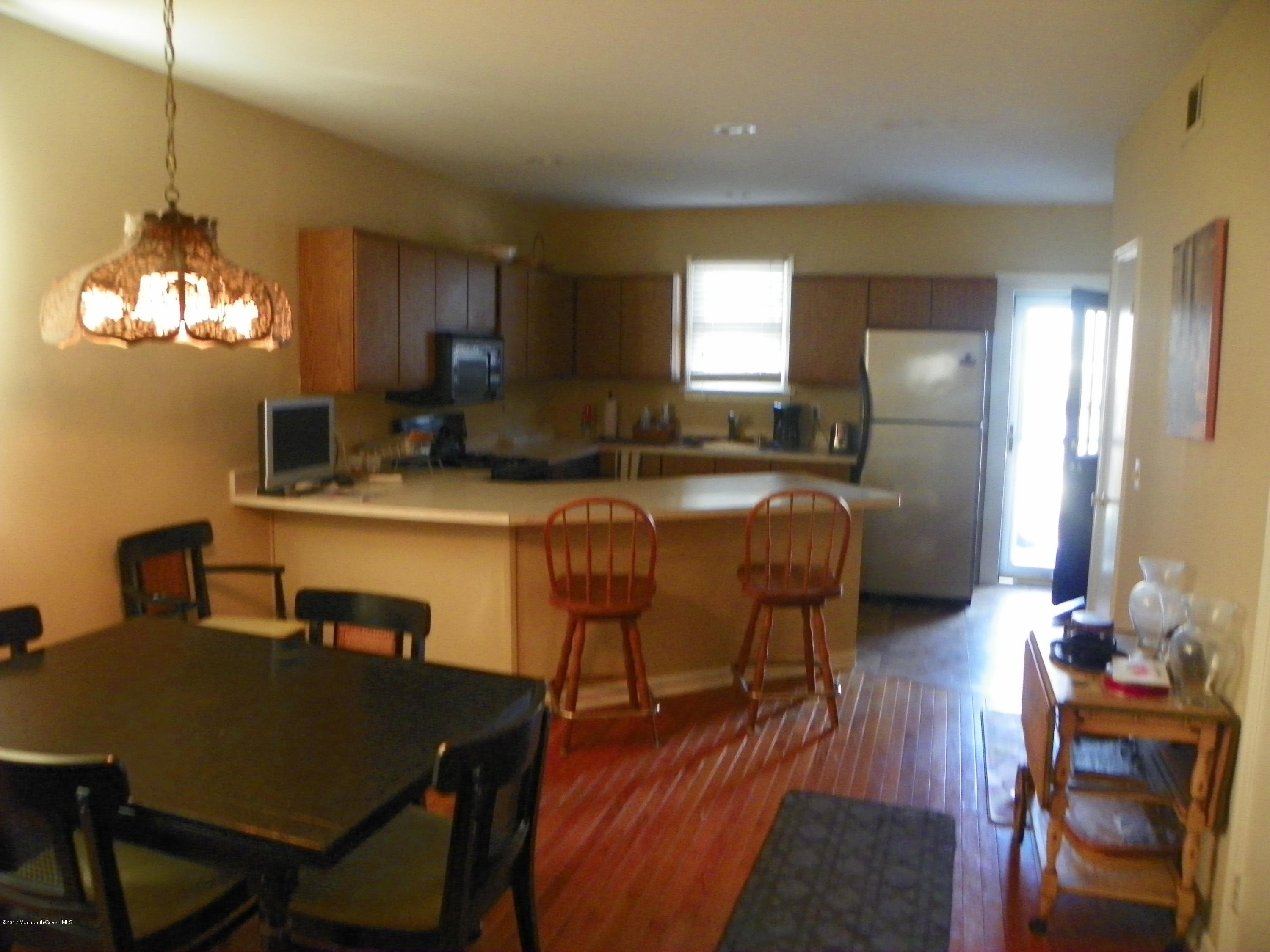 19 Rector Place Red Bank, NJ 07701 - Photo 8 of 13 a view of a dining room with furniture and a chandelier