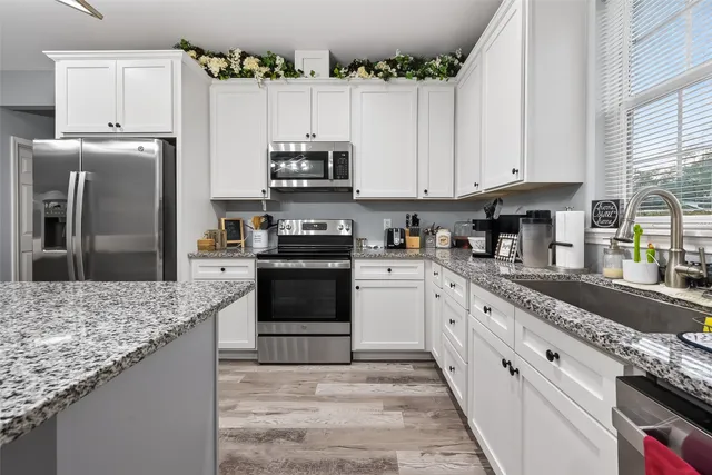 a kitchen with sink cabinets and stove