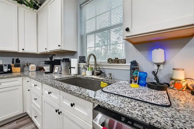 a kitchen with stainless steel appliances granite countertop a stove and a microwave