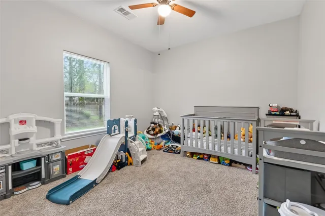 a room with furniture and baby crib