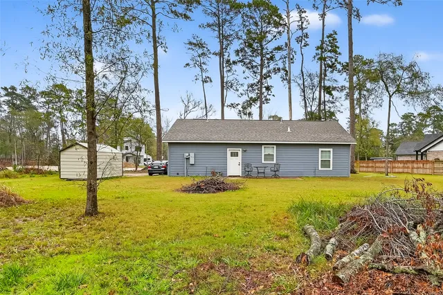 a front view of house with yard and trees