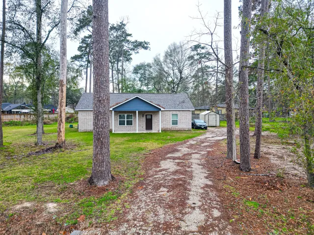 a aerial view of a house with yard swimming pool and outdoor seating