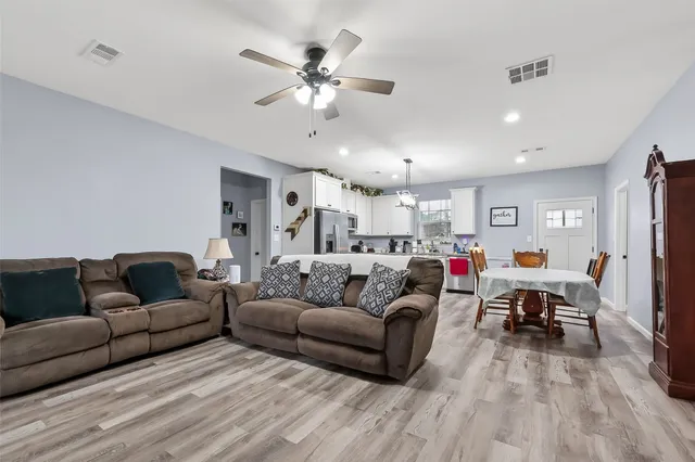 a living room with furniture and a chandelier