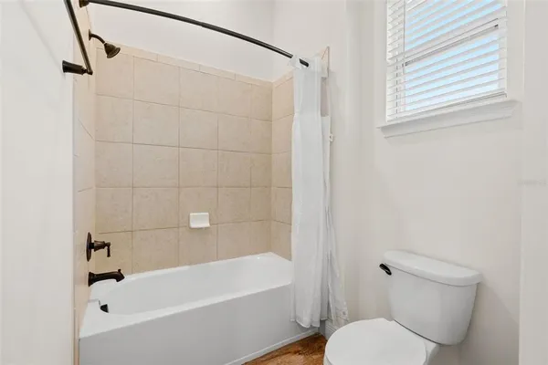 a bathroom with a toilet and a bathtub