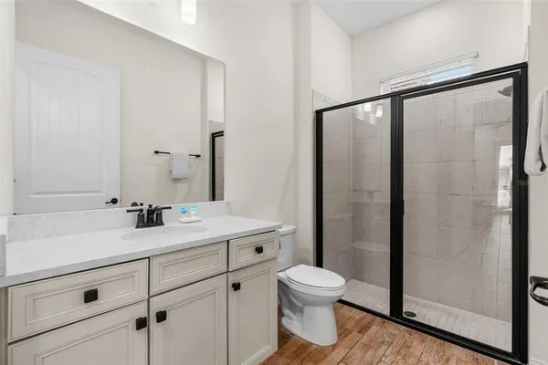 a bathroom with a toilet a sink and shower