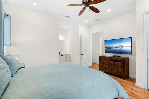 a bedroom with a bed and a flat screen tv