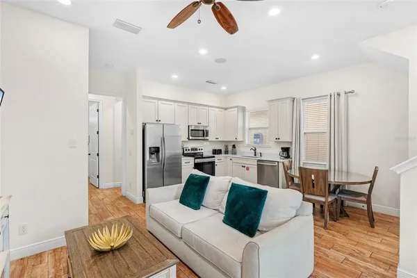 a living room with furniture and kitchen view