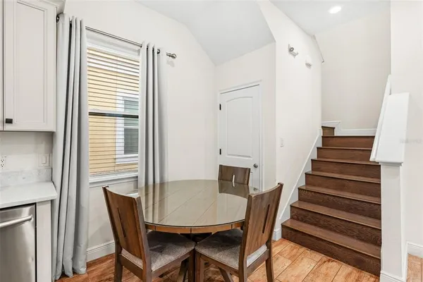 a view of a dining room with furniture and wooden floor