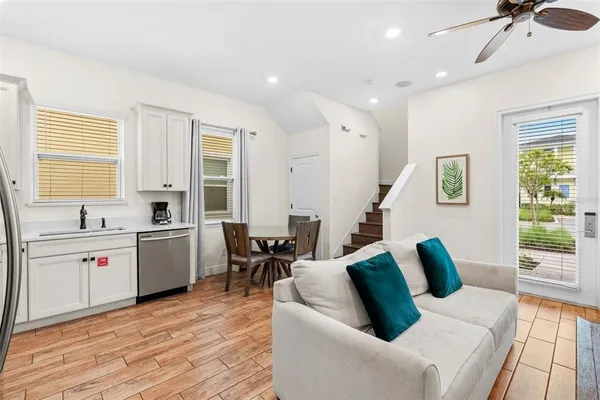 a living room with furniture and wooden floor