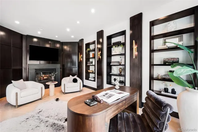 a living room with fireplace furniture and a flat screen tv